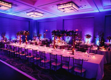 Decorated banquet hall with flowers, rectangle table, chiavari c